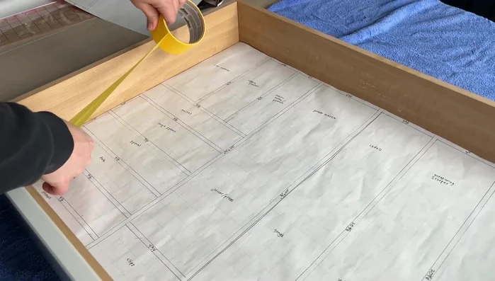 Glue and assemble the wood dividers, using the paper template as a guide. Ensure a tight fit and use clamps or painter's tape to hold pieces in place while the glue dries.