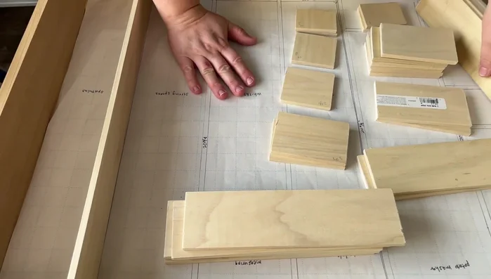 Glue and assemble the wood dividers, using the paper template as a guide. Ensure a tight fit and use clamps or painter's tape to hold pieces in place while the glue dries.