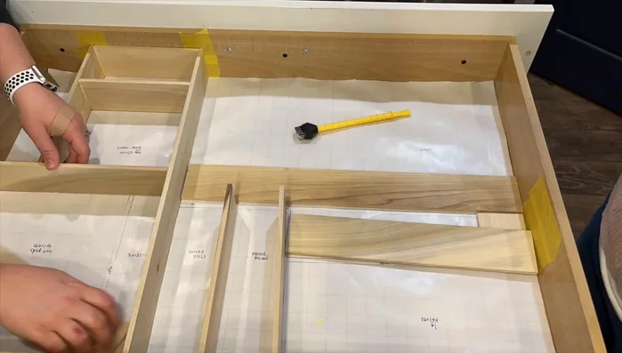 Remove the paper template and painter's tape. Place the finished organizers in the drawer and arrange your items.