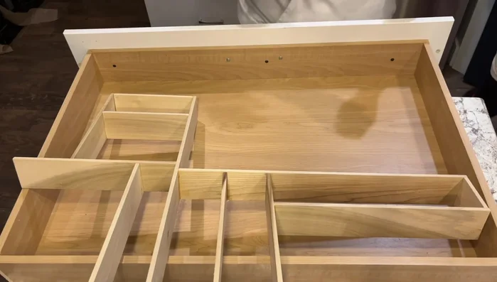 Remove the paper template and painter's tape. Place the finished organizers in the drawer and arrange your items.