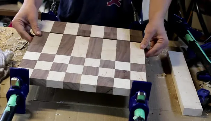 Glue up the strips, rotating every other strip 180° for the checkered pattern. Carefully align the edges during clamping.