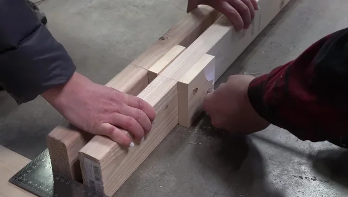Attach the 1x4s to the 2x4s using 3 1/2 inch screws, ensuring they are countersunk below the surface.