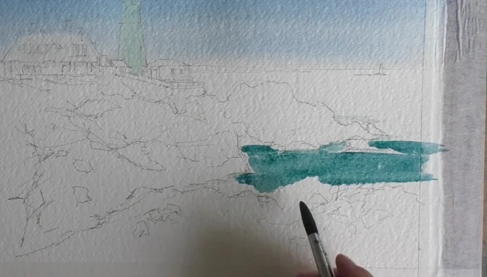 Paint the sea using the same sky mix with added Sap Green, dropping in wet-on-wet Ultramarine blue.