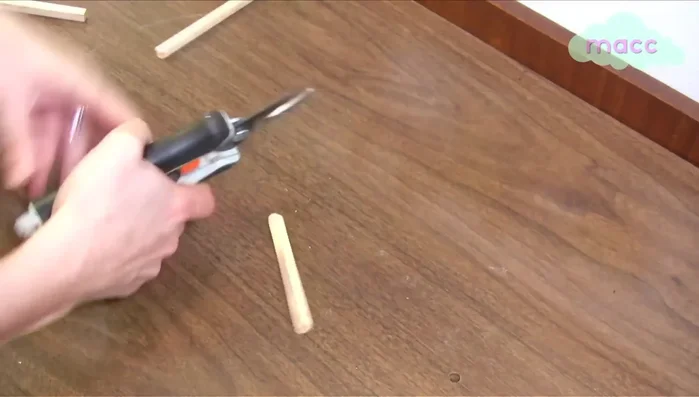 Drill a hole (half an inch down from the top) into the center of each dowel.