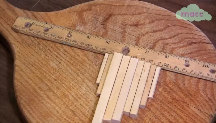 Drill a hole (half an inch down from the top) into the center of each dowel.