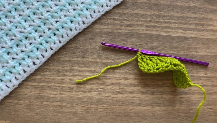 To change colors, snip the old yarn and pull a loop of the new color through the current loop on your hook. Secure the new color by pulling both tails.