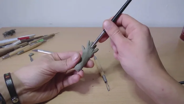 Blend the fingers: Use a sculpting tool to smoothly blend the fingers to the palm, paying close attention to the connection points.