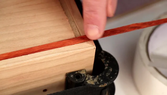 Glue and miter the inlay strips to create a seamless inlay.