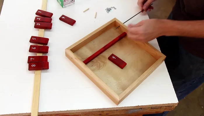 Assemble the flippers onto the steel rod, adding washers between each piece. Glue in a wood dowel to secure the rod.