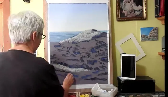 Adding lighter highlights (grays and lighter colors) to the tops of the rocks, blending with the hand in the direction of the rock shapes.