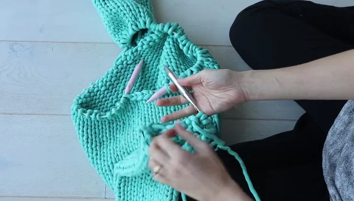 Repeat step 3 for the second sleeve, knitting the sleeve stitches onto the same needle as the body stitches.