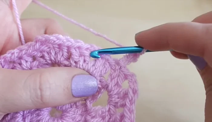 Work five treble crochets in the last space. Slip stitch to the top of the beginning chain three.