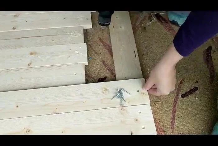 Assemble the backdrop: Attach the 43-inch boards to either side of the 60-inch boards using screws and the pre-drilled holes.