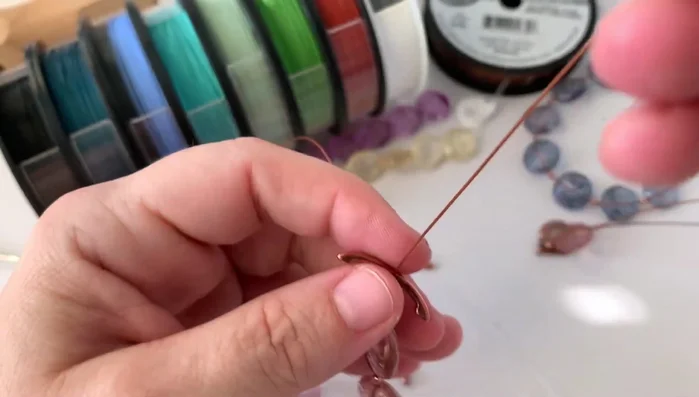 Crimp the final tube: Securely crimp the final tube, ensuring the clasp is positioned correctly on the outside of the loop.