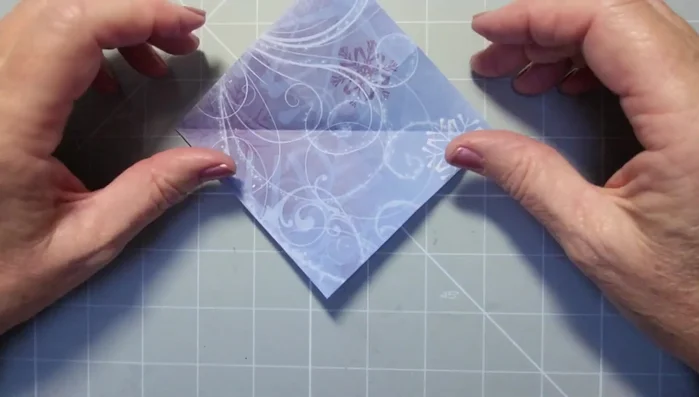 Pinch and fold the closed side over to the center line, creating a crease.
