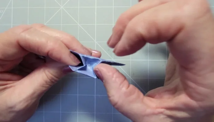 Fold the points of the diamonds into the center to create the bow loops.