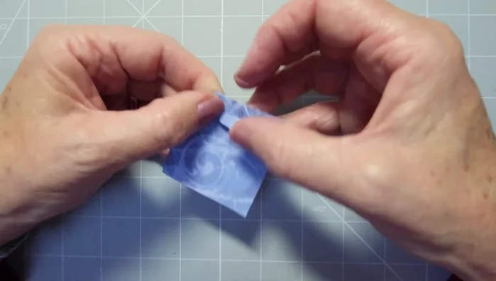 Fold the points of the diamonds into the center to create the bow loops.