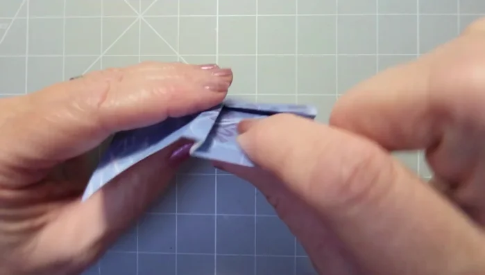 Fold the points of the diamonds into the center to create the bow loops.