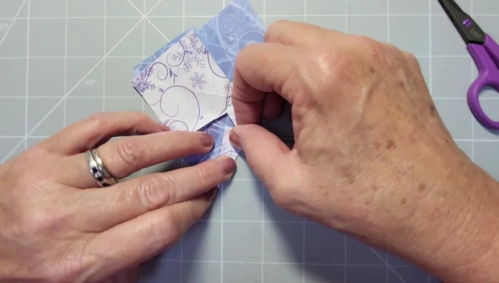 Fold the points of the diamonds into the center to create the bow loops.