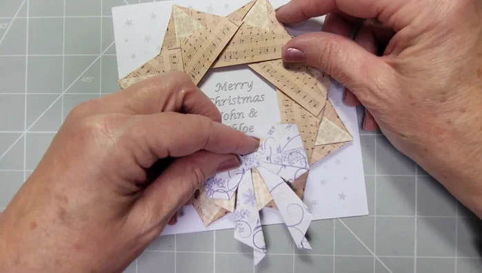Attach the bow to the completed origami star wreath.