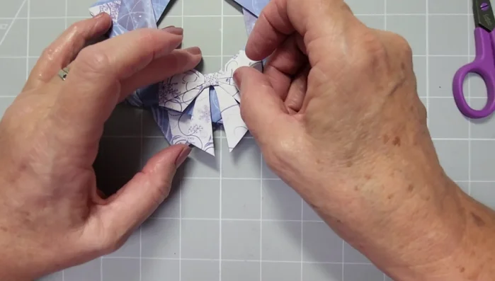 Attach the bow to the completed origami star wreath.