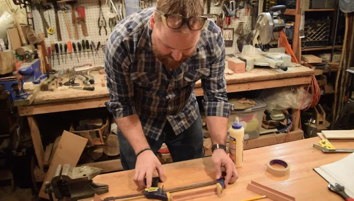 Assemble the Sides: Glue and clamp the triangular sides to the base, ensuring proper alignment and removing excess glue.