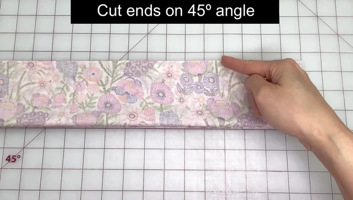 Cut ends at a 45-degree angle. Use a quilting template or crease the fabric to mark the angle.