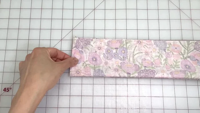 Sew along the notches using a 1/4 inch seam allowance. Pivot at corners and sew along the folded edge.