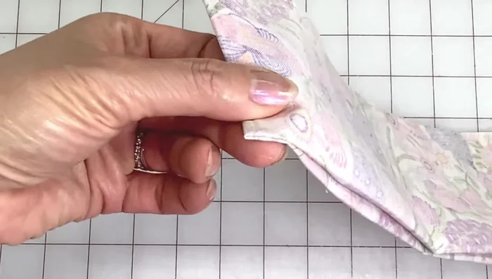 Sew along the notches using a 1/4 inch seam allowance. Pivot at corners and sew along the folded edge.