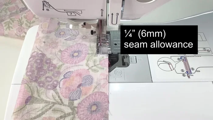 Sew along the notches using a 1/4 inch seam allowance. Pivot at corners and sew along the folded edge.