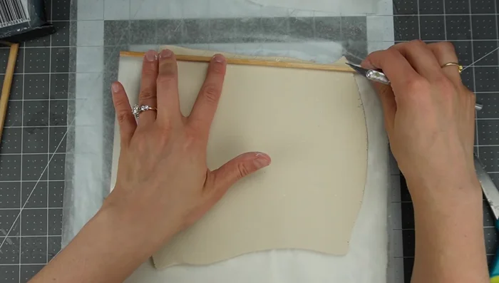 Cut the clay to the size of your wall, using a template if needed.