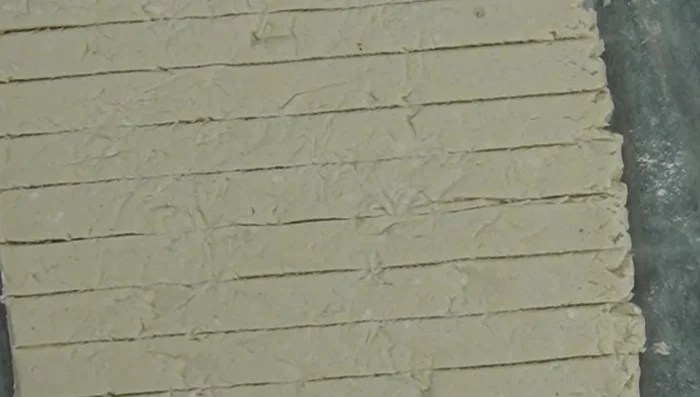 Add texture using crumpled aluminum foil before cutting lines.