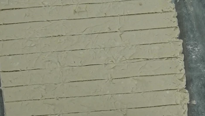 Add texture using crumpled aluminum foil before cutting lines.