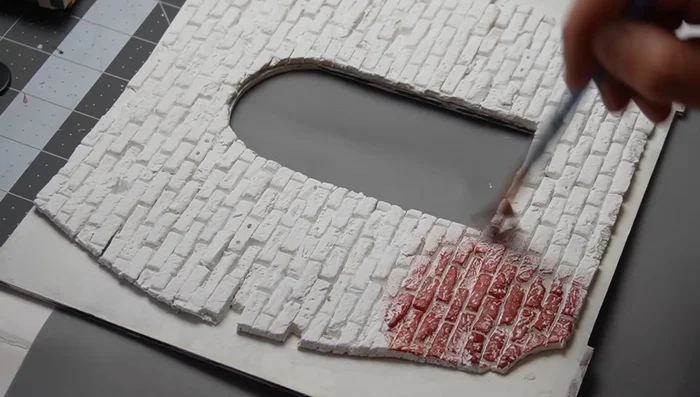 Apply brick color: Use a sponge for best results to fill in texture while keeping grout lines clean.