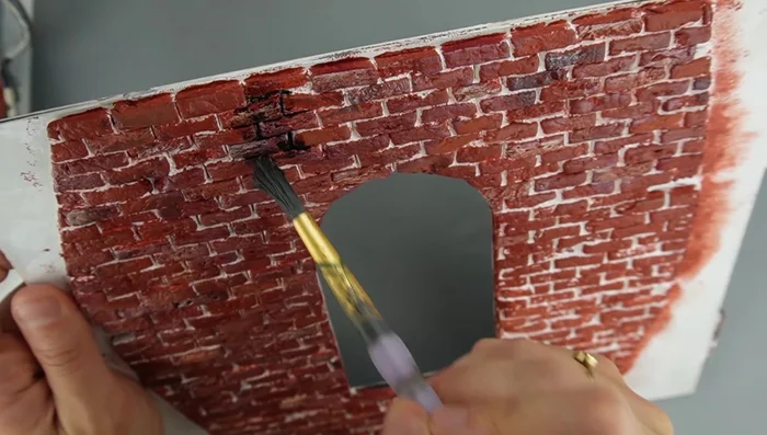 Add flocking: Mix flocking with glue and smudge onto the surface to simulate moss and enhance details.