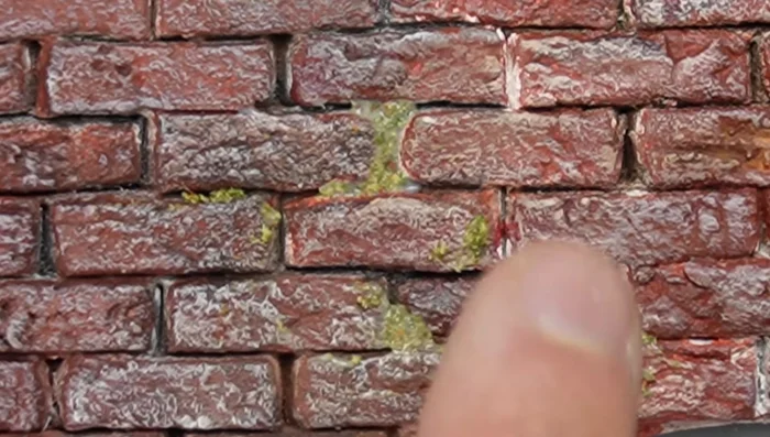 Add flocking: Mix flocking with glue and smudge onto the surface to simulate moss and enhance details.