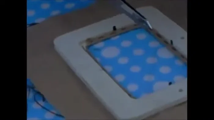 Fold and stitch the fabric. Fold the fabric over the metal posts and stitch around the frame, securing the fabric to the frame. Ensure the fabric is taut and neatly folded around the corners.