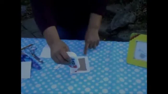 Glue and dry the back. Apply glue to the poster board and attach it to the back of the picture. Allow to dry.