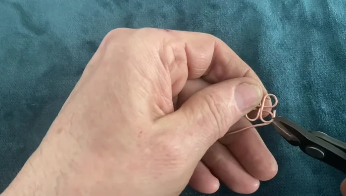Cut the sterling silver wire to the desired length and shape the knots using the jig. Make sure the overall length is slightly shorter than needed for later stretching.