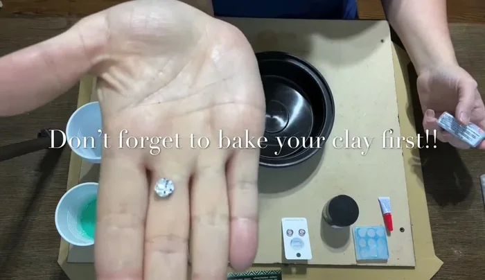 Secure the design to an empty takeout container using cheap glue to prevent it from floating during the mold-making process.