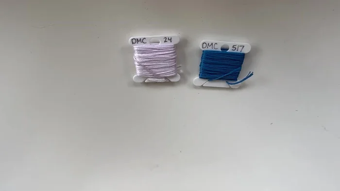 Prepare your floss: Tie the two ends of the floss of the same color together at one end. Leave some extra length for tying off later.