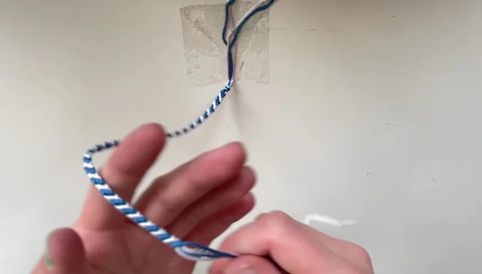 Finish the bracelet: Once the bracelet is the desired length, tie off the end with a knot. (Optional: Add decorative ties.)