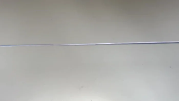 Prepare your floss: Tie the two ends of the floss of the same color together at one end. Leave some extra length for tying off later.