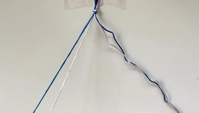 Start knotting: Begin by using a forward knot (explained in the video) alternating between your two colors. Use one string as the base and the other as the leading string. Always make each knot twice.