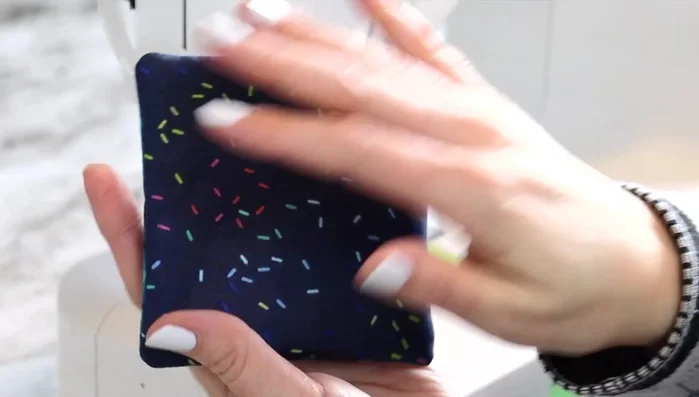 Top stitch: Using a longer stitch length, top stitch around the entire coaster, closing the opening. Start in the middle and follow along the edge of the sewing foot for consistent stitching.