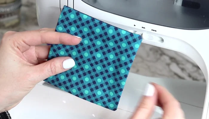 Top stitch: Using a longer stitch length, top stitch around the entire coaster, closing the opening. Start in the middle and follow along the edge of the sewing foot for consistent stitching.
