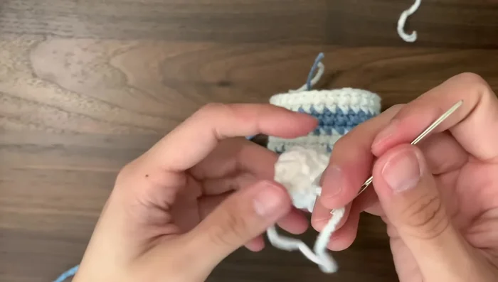 Attach wings to the bee body, using yarn needle to secure.