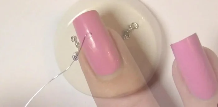 Make clay charms. Bend wire, insert into clay, and bake. Paint with silver alcohol ink after baking.