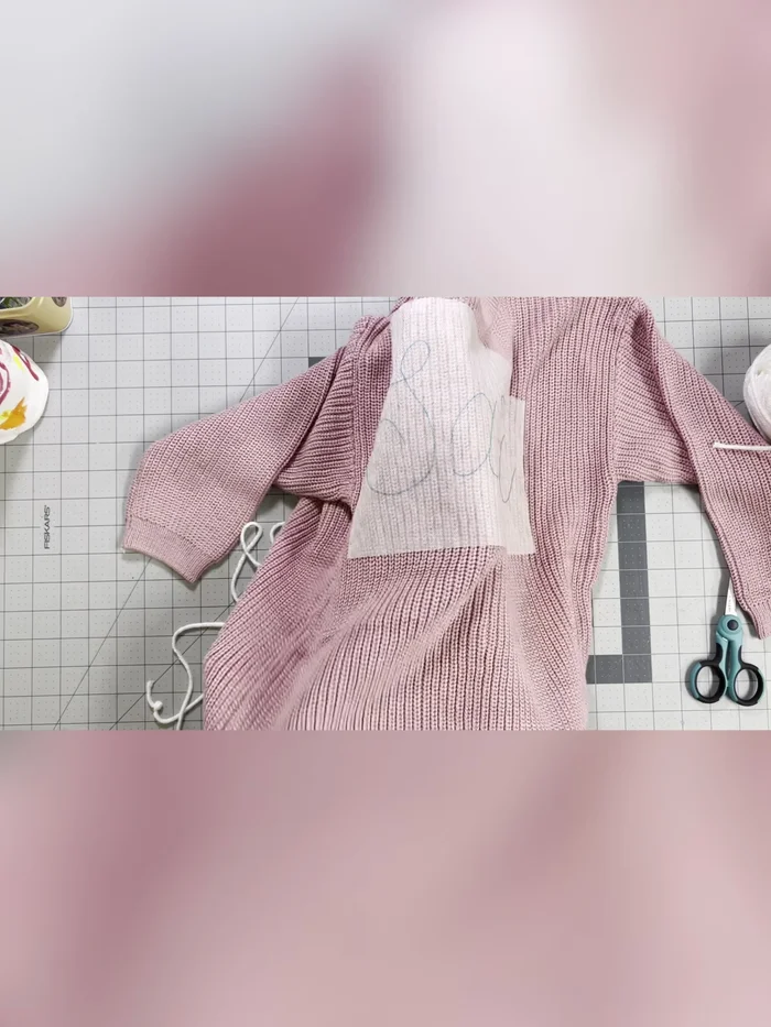 Gently tug on the back of each stitch to create even, tight stitches. Continue the chain stitch around your name.