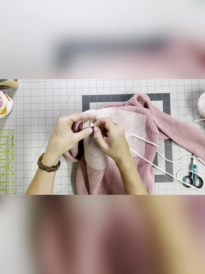 Gently tug on the back of each stitch to create even, tight stitches. Continue the chain stitch around your name.